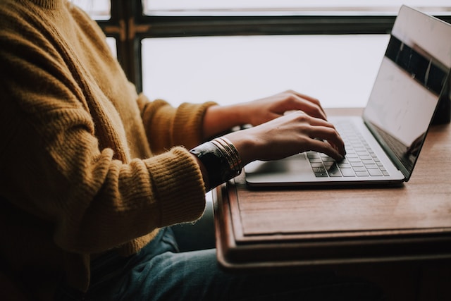 Photo of a person typing on a laptop by Christin Hume on Unsplash